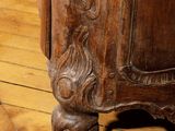 a close up of a wooden cabinet on a hard wood floor