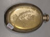a gold flaskt with a picture of a bird on it
