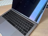 a laptop computer sitting on a desk with a keyboard