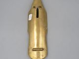 a close up of a gold metal object on a gray surface