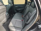 the back seats of a car are empty and the passenger seat is empty
