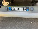 a license plate on the back of a yellow truck