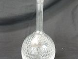 a glass vase that is sitting on a table