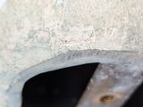 a close up of a piece of metal with a hole in it