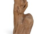 an image of a statue of a woman sitting on a white surface