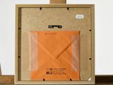 a picture of an orange envelope in a picture frame