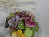 a white chair with a basket of flowers on it