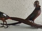 two birds that are standing next to each other on a table