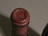 a bottle of wine sitting on a counter next to a bottle of wine