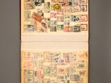 an open book with stamps on it on a table