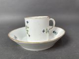 a close up of a cup and saucer on a table