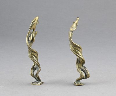 pair of brass figurines of a bird and a fish