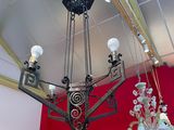 a chandelier in the middle of a room with red walls