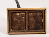 an old wooden box with a pipe sticking out of it