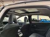 the interior of a car with the door open and the driver ' s seat down