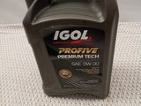 a close up of a bottle of engine oil on a table