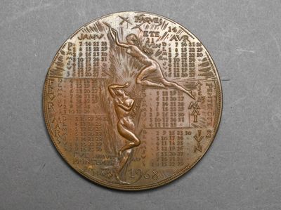 a close up of a bronze medal with a woman on it