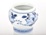 a blue and white vase sitting on a white surface