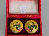 pair of yellow and red porcelain salt and pepper shakers in a red box