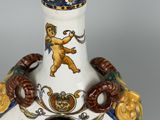 a white vase with a blue and gold design on it