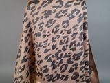 a brown and black leopard print scarf on a mannequin mannequin mannequin mannequin mannequin mannequin mannequin manne