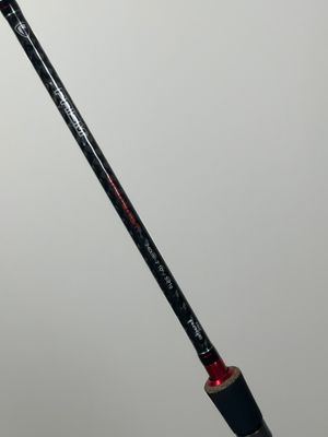 a close up of a person holding a fishing rod in their hand