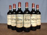 six bottles of wine are lined up on a table