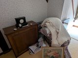 a picture of a bedroom with a bed and a picture on the floor