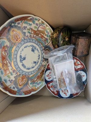 a box with a variety of decorative plates in it