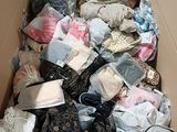a cardboard box filled with clothes and other items