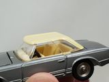a person holding a toy car in their hand