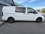 the white van is parked in the parking lot outside of the building