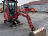 an image of a small excavator in a parking lot