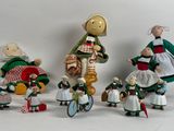 five figurines of people dressed in traditional clothing