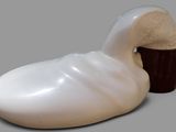 a white duck shaped object with a bucket of ice cream