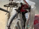 a bike that is parked in a garage with a hose attached to it