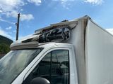 a white truck with a roof rack on top of it