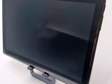 a tablet computer sitting on a stand on a white surface