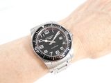 a person that is holding a watch on their wrist