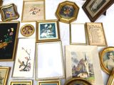 a table with a lot of framed pictures and pictures on it