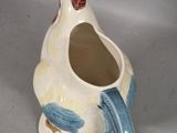 a white and blue vase with a bird on it