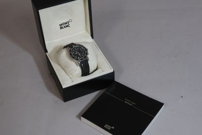 a black and white watch in a box on a table