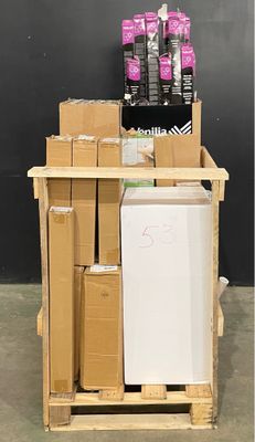 a small refrigerator sitting on a pallet next to a pile of boxes