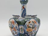 an image of a blue and white vase with flowers on it