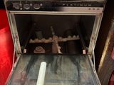 an open oven with a roll of paper inside of it