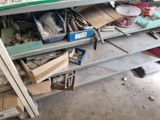 a lot of tools on a shelf in a garage