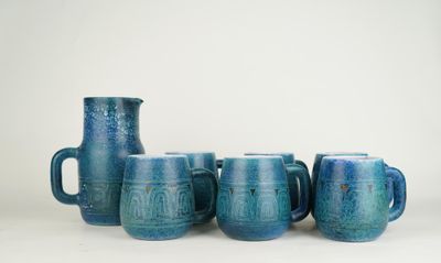 five blue mugs sitting next to each other on a table