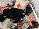 a pile of clothes and other items in a bin