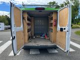 a white van with a green roof parked in a parking lot