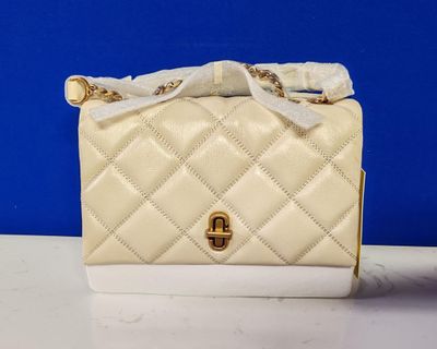 white quilted purse with gold hardware